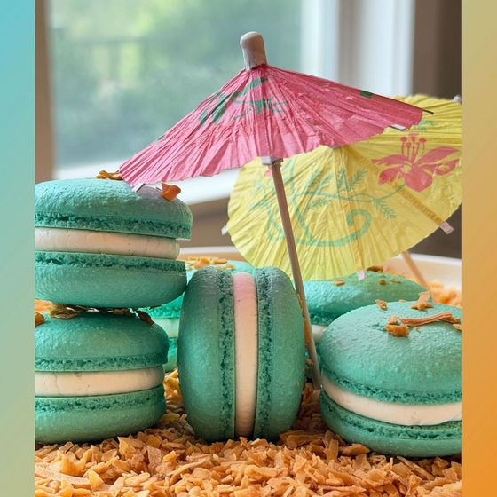 Teal Beach Bonfire macarons under a pink cocktail umbrella