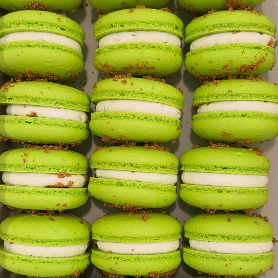Bright green key lime pie macarons packed in rows